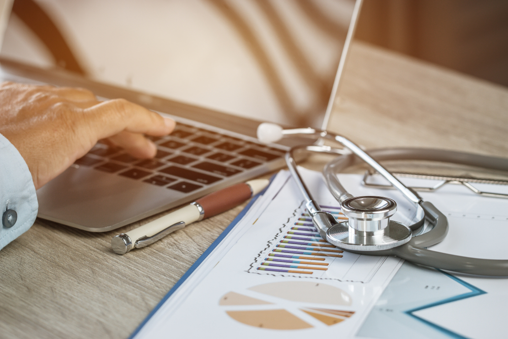 medical practitioner doing their accounting on a laptop