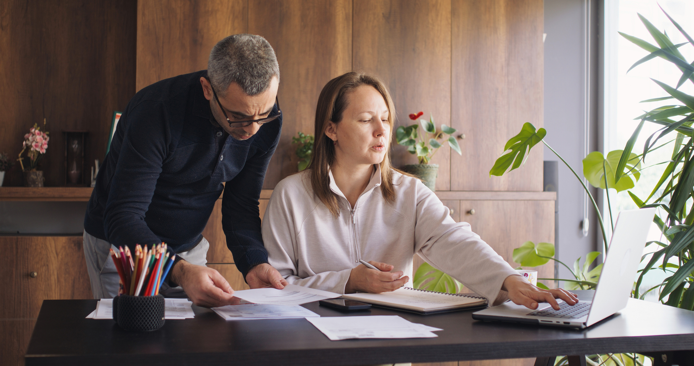 Archer Lewis assurance specialists reviewing financial statements with a client