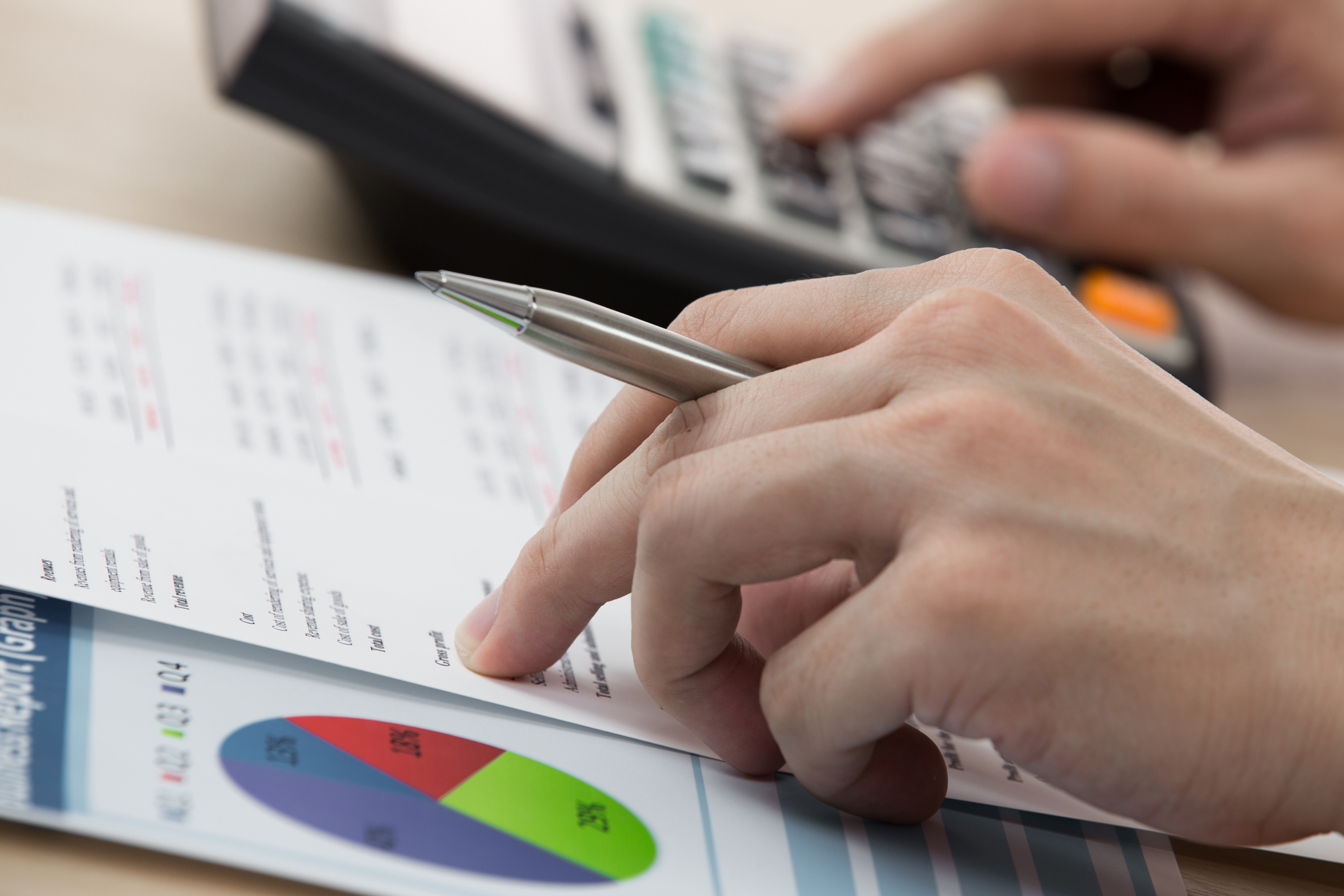 Archer Lewis controller reviewing financial reports with a business leadership team